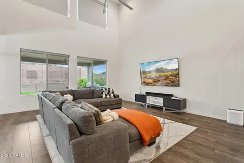 a living room with furniture a rug and a large window