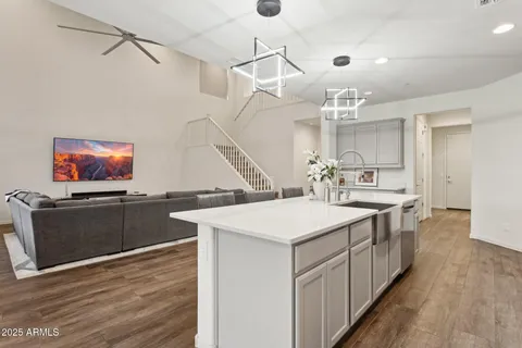 a large kitchen with sink cabinets and wooden floor