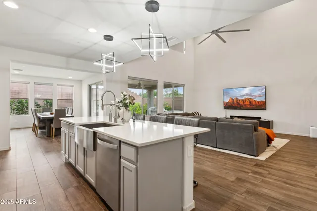 a kitchen with stainless steel appliances granite countertop a stove and a wooden floors