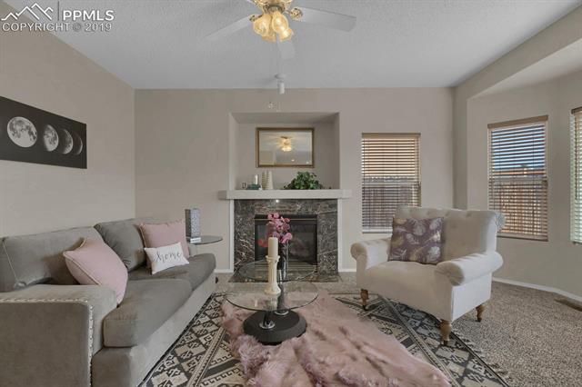 4415 Fencer Road Colorado Springs, CO 80911 - Photo 14 of 27 Inviting and cozy Family room with built-in nook above the gas fireplace.