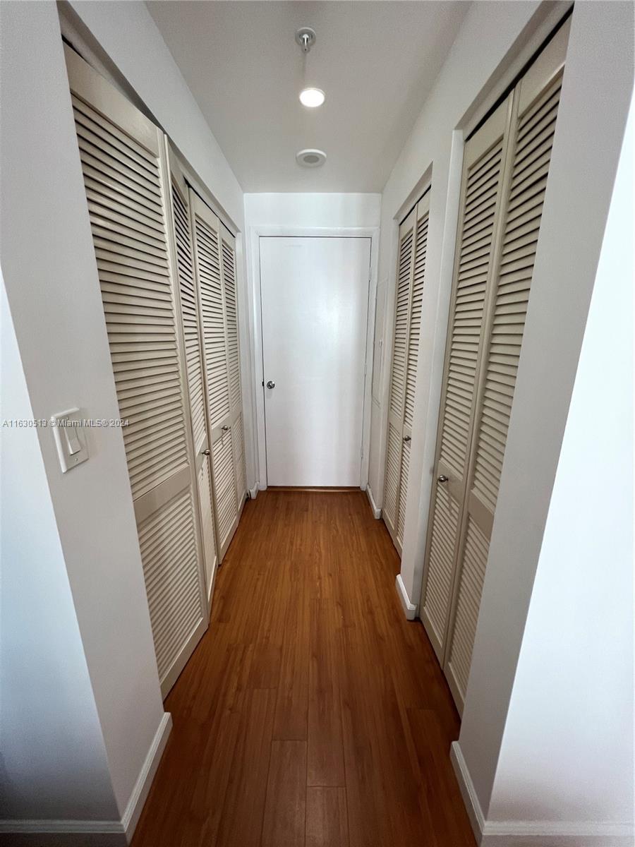 801 Brickell Key Boulevard, Unit 1506 Miami, FL 33131 - Photo 11 of 23 a view of a hallway with wooden floor and staircase