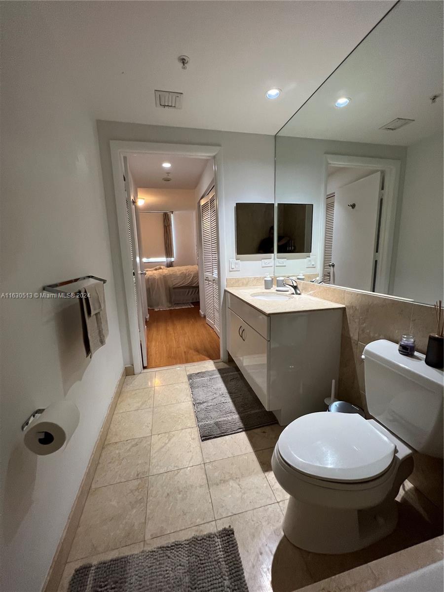801 Brickell Key Boulevard, Unit 1506 Miami, FL 33131 - Photo 13 of 23 a bathroom with a toilet a sink a mirror and shower