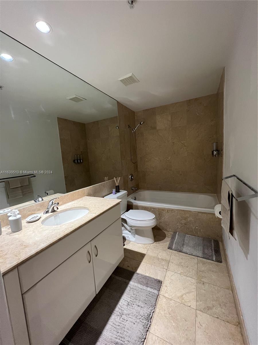 801 Brickell Key Boulevard, Unit 1506 Miami, FL 33131 - Photo 14 of 23 a bathroom with a double vanity sink toilet and shower