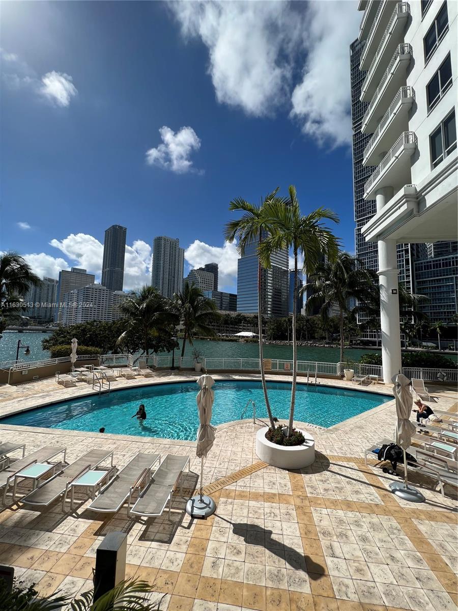 801 Brickell Key Boulevard, Unit 1506 Miami, FL 33131 - Photo 20 of 23 a view of a building with sitting area and swimming pool