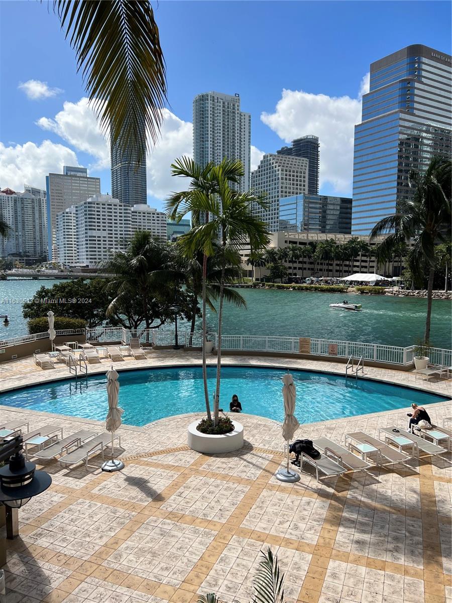 801 Brickell Key Boulevard, Unit 1506 Miami, FL 33131 - Photo 21 of 23 a view of a swimming pool with a patio and a lake view