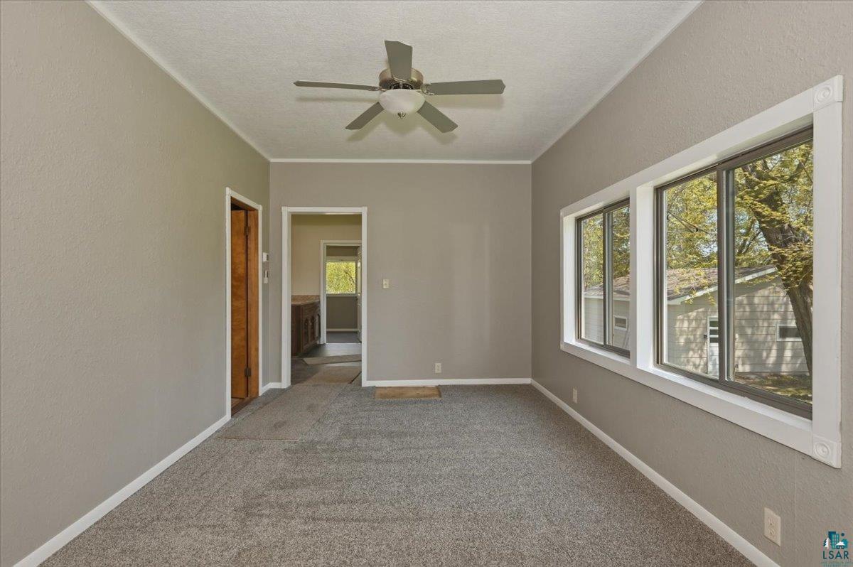 5319 East 3rd Street Superior, WI 54880 - Photo 17 of 33 Neutral-toned room featuring textured walls, grey carpet flooring, and white trim