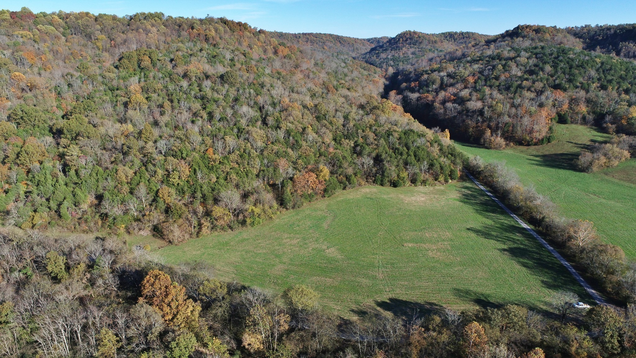0 Sweetwater Road Liberty, TN 37095 - Photo 9 of 16 a view of a lush green hillside and a houses