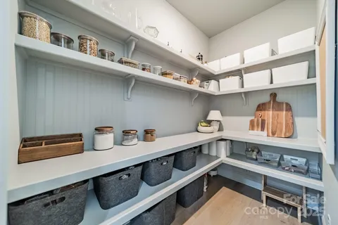 a kitchen with a cabinets and wooden floor
