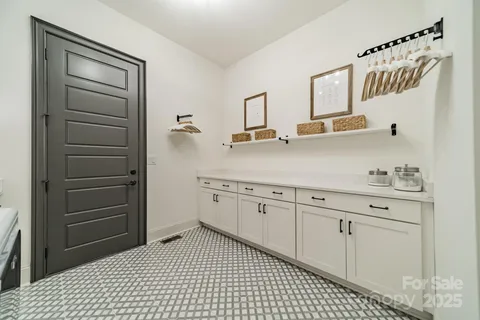 a kitchen with a refrigerator sink and cabinets
