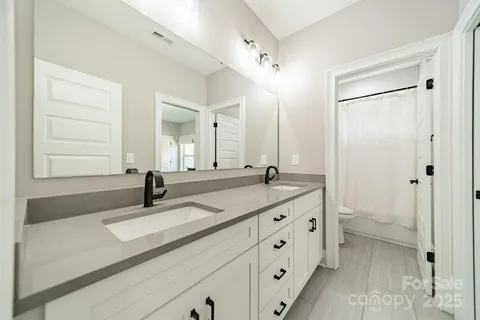 a spacious bedroom with a bed and a table chair