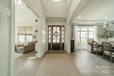 a living room with furniture and large windows
