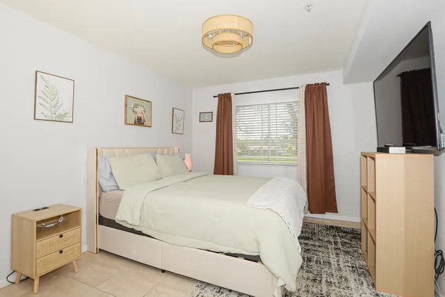 a bedroom with a bed and a flat screen tv