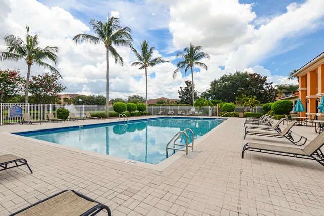 a view of swimming pool with outdoor seating and city view