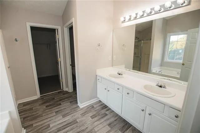 a bathroom with a double vanity sink and mirror