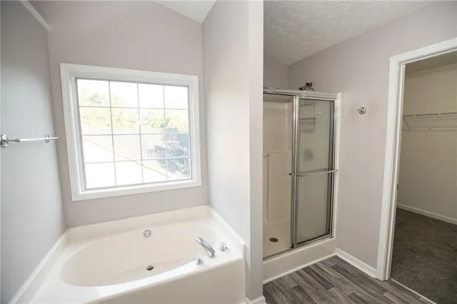 a white bath tub sitting in a bathroom next to a window