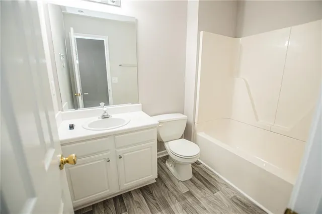 a bathroom with a sink toilet a mirror and shower