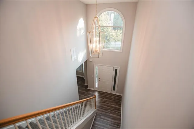 a view of a hallway with wooden floor and a window