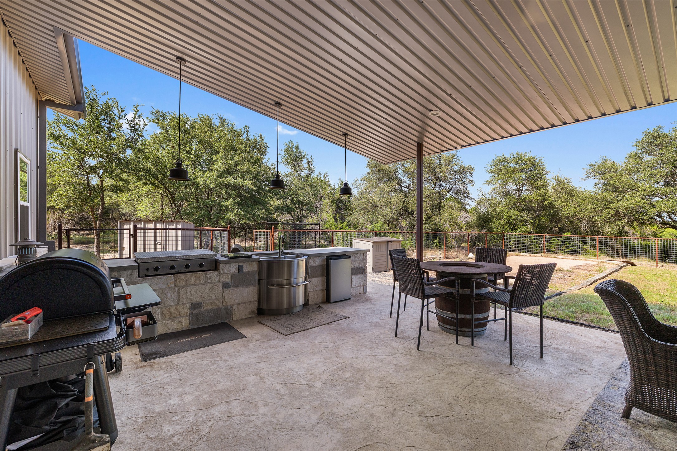 764 Stubbs Road Johnson City, TX 78636 - Photo 6 of 29 An inviting outdoor kitchen and dining area provides the perfect setting for entertaining.