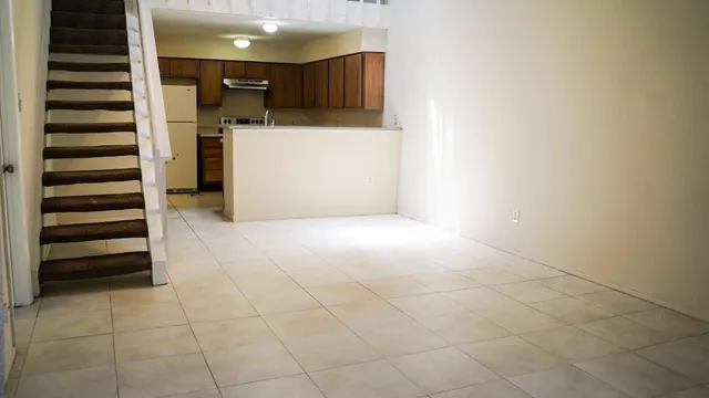 a view of hallway with stairs and a window