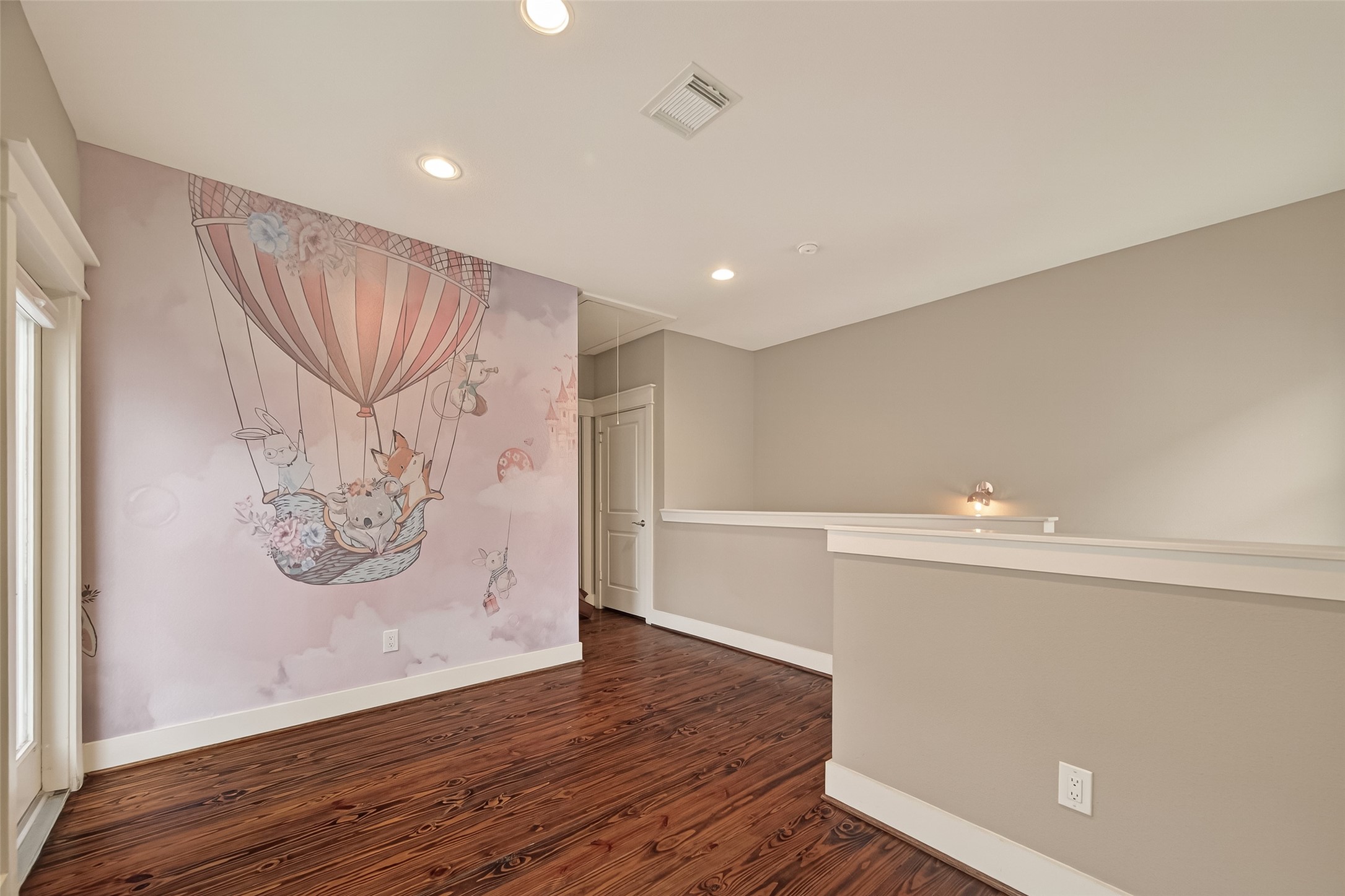 1510 Crockett Street, Unit B Houston, TX 77007 - Photo 22 of 32 a view of an empty room with wooden floor and a window