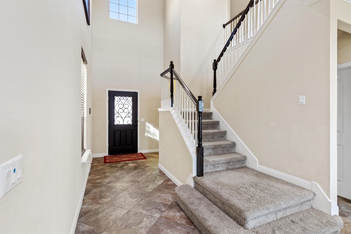 9404 Ocean Going Court Austin, TX 78748 - Photo 11 of 40 Entryway with healthy amount of natural light, a high ceiling, and stairway
