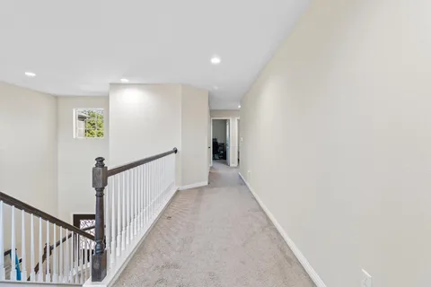 a living room with furniture a flat screen tv and a large window