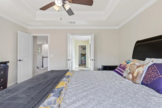 a bedroom with a bed and a ceiling fan