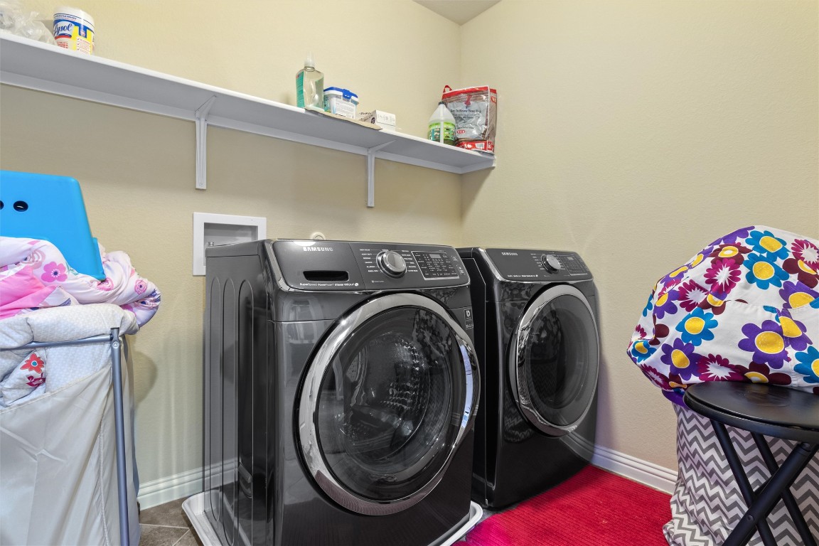 9404 Ocean Going Court Austin, TX 78748 - Photo 23 of 40 Laundry room featuring washer and dryer and tile patterned floors
