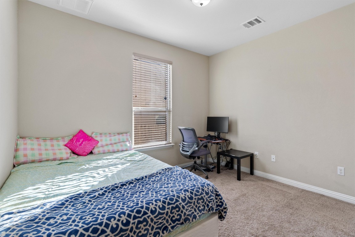 9404 Ocean Going Court Austin, TX 78748 - Photo 29 of 40 a bedroom with a bed and a window