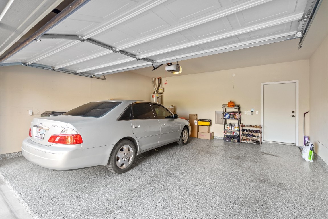 9404 Ocean Going Court Austin, TX 78748 - Photo 35 of 40 Garage with a garage door opener and water heater