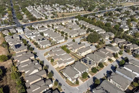 an aerial view of a house with backyard