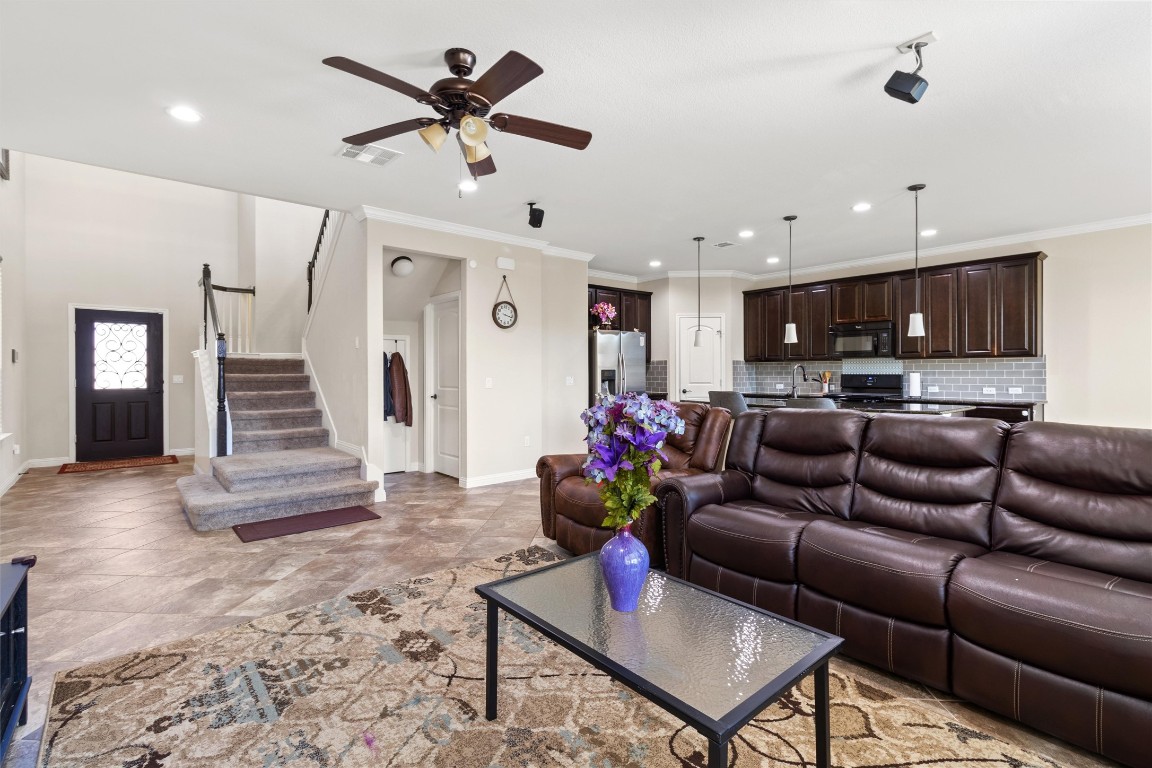 9404 Ocean Going Court Austin, TX 78748 - Photo 6 of 40 Living room with ceiling fan, stairway, ornamental molding, and recessed lighting