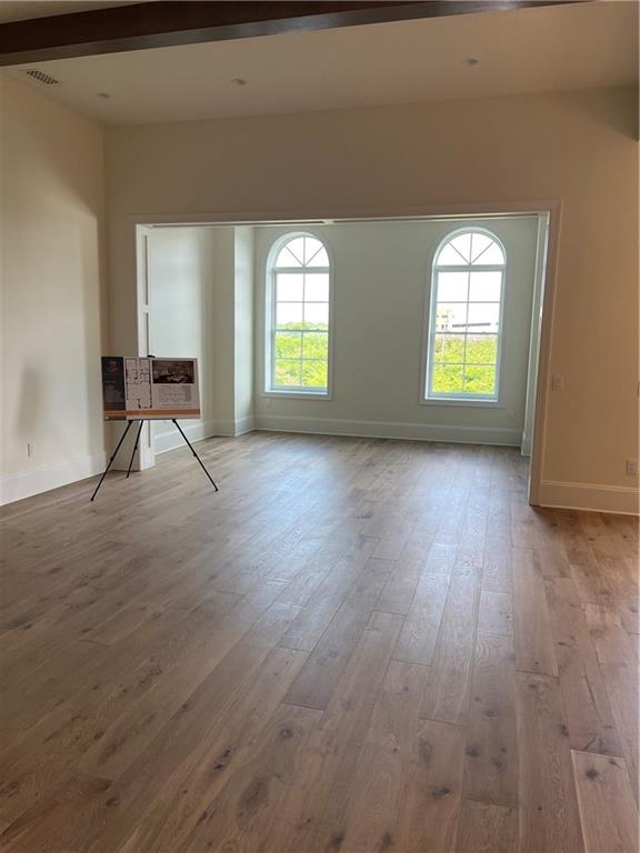 106 Spring Street Gainesville, GA 30501 - Photo 17 of 18 an empty room with wooden floor and windows