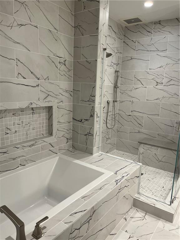 106 Spring Street Gainesville, GA 30501 - Photo 18 of 18 a bathroom with a bathtub and shower