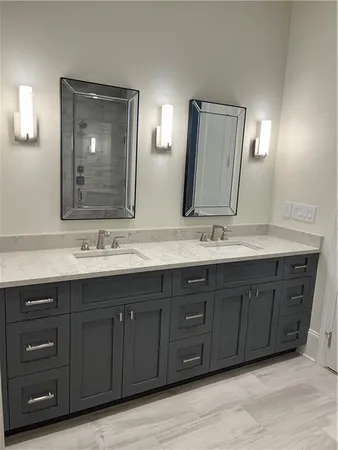 a bathroom with a double vanity sink and a large mirror