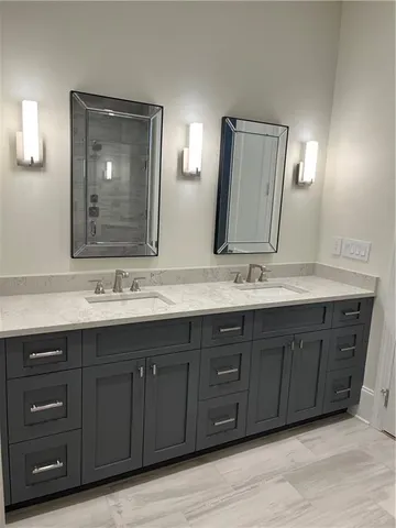 a bathroom with a double vanity sink and a large mirror