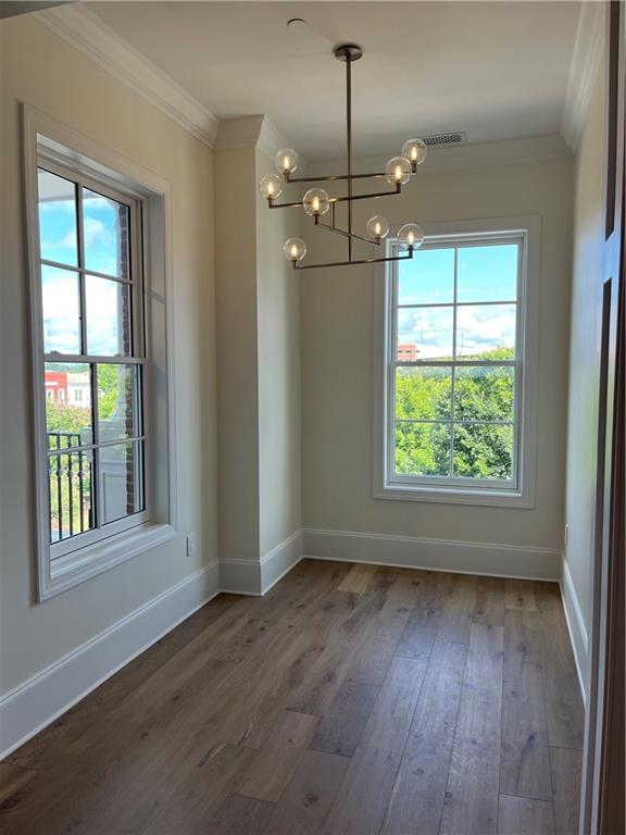 106 Spring Street Gainesville, GA 30501 - Photo 8 of 18 a view of an empty room with wooden floor and a window