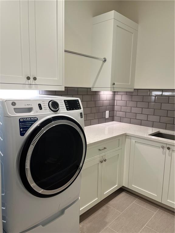 106 Spring Street Gainesville, GA 30501 - Photo 10 of 18 a utility room with sink dryer and washer