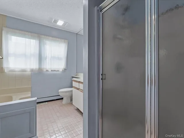 a bathroom with a granite countertop toilet a sink and a bathtub