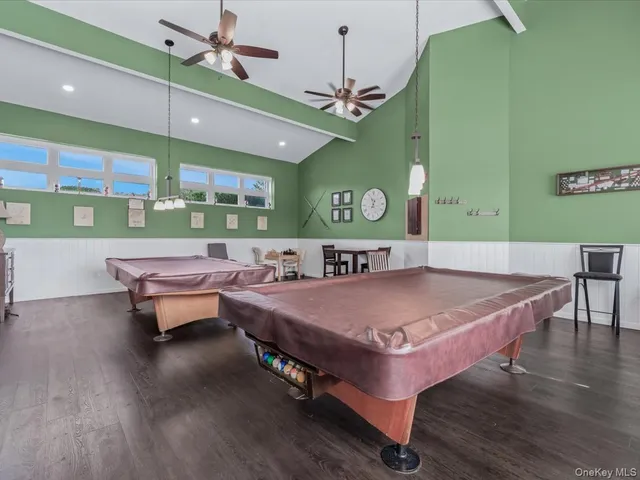 a room with pool table and windows