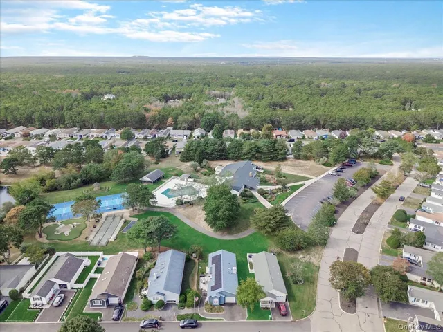 an aerial view of residential houses with outdoor space and street view