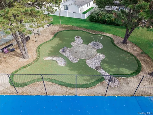 a picture of a table and chairs in a garden