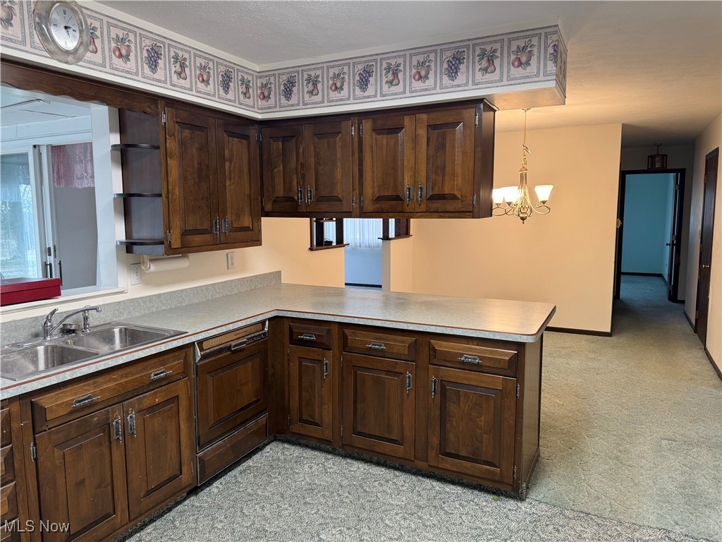 68697 Morristown Flushing Road Flushing, OH 43977 - Photo 17 of 33 Kitchen featuring a peninsula, dishwasher, dark brown cabinets, and a sink