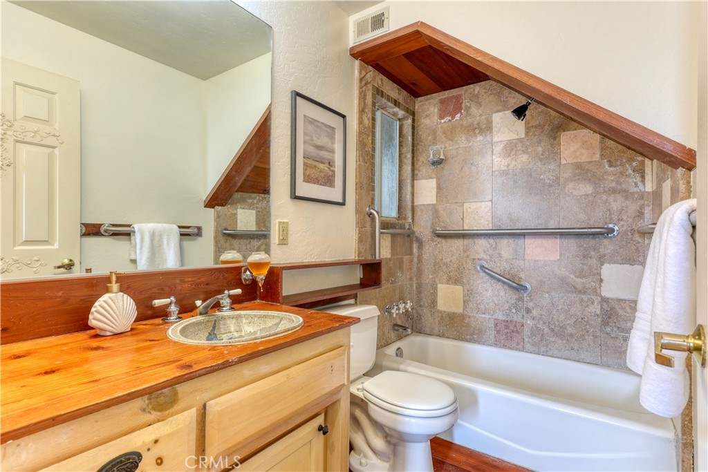 564 Croyden Lane Cambria, CA 93428 - Photo 28 of 64 a bathroom with a granite countertop sink and a bathtub