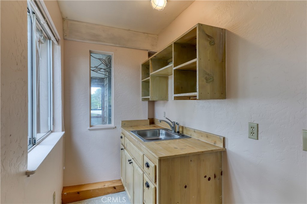 564 Croyden Lane Cambria, CA 93428 - Photo 36 of 64 a kitchen with a sink and a window
