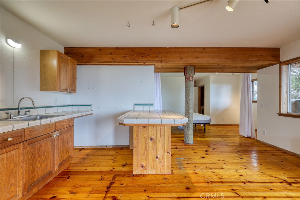 564 Croyden Lane Cambria, CA 93428 - Photo 50 of 64 a view of a kitchen with kitchen island stainless steel appliances a sink and cabinets