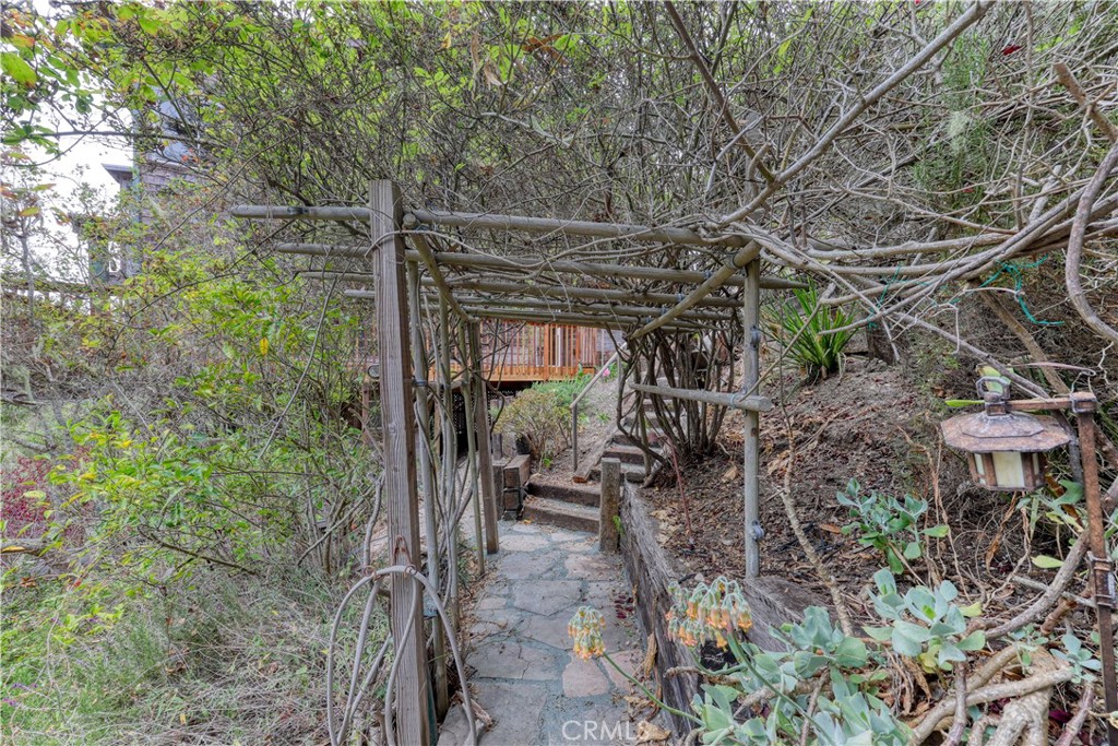 564 Croyden Lane Cambria, CA 93428 - Photo 59 of 64 a view of a patio with table and chairs and potted plants