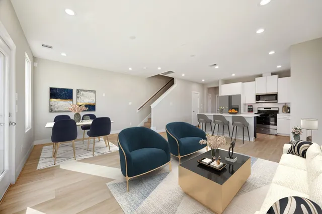 a living room with furniture kitchen view and a chandelier
