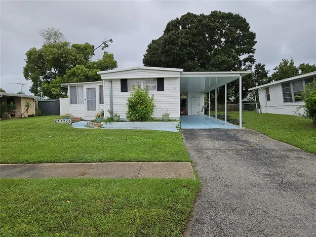 a front view of a house with a yard and porch