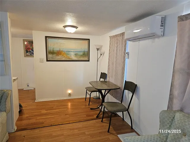 a view of a room with furniture and wooden floor